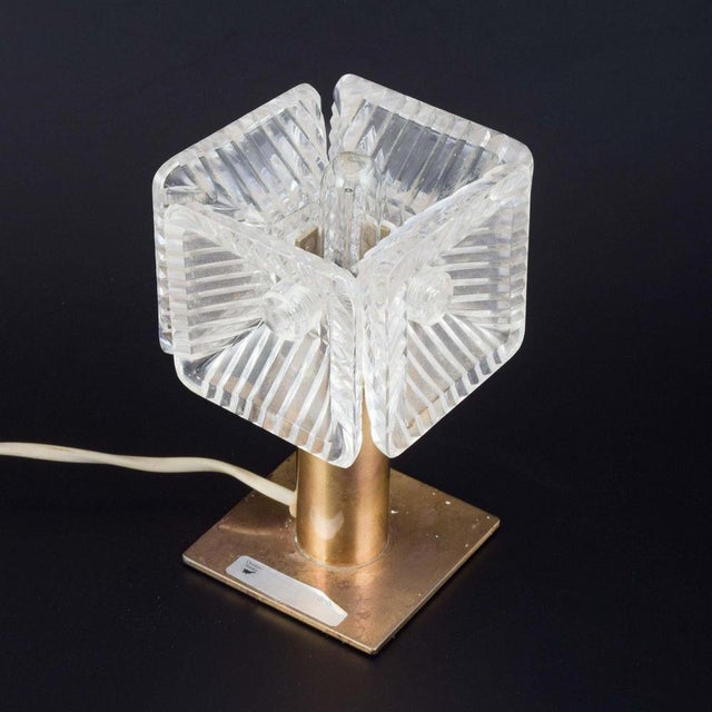 Carl Fagerlund for Orrefors. Brass table lamp with crystal glass shade. 1960s. Table lamp with four-sided shade in cut...
