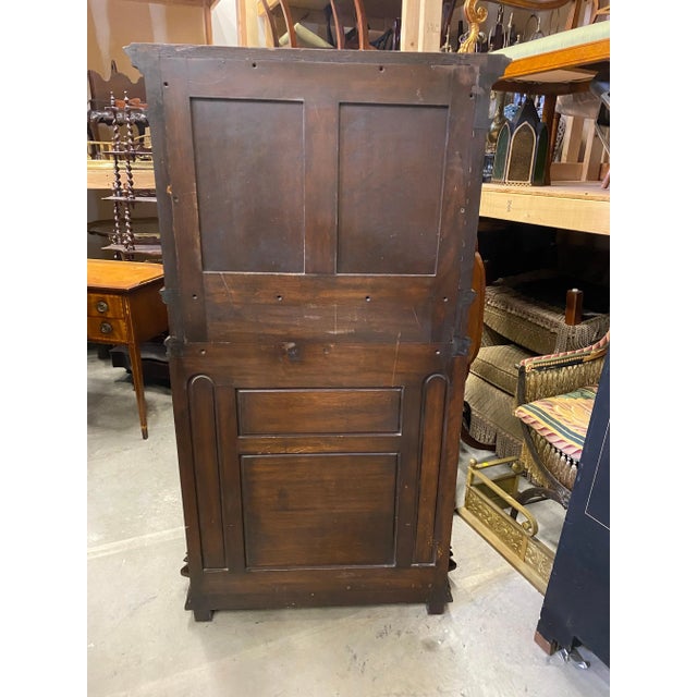 Handsome and stately hand carved English Tudor court cupboard. The top section with door with elaborately hand carved...