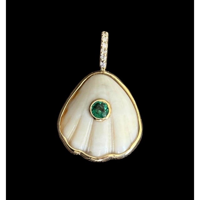 Shell Pendant with Center Emerald, Gold Bezel and Diamond Bail Shell, Emerald, Diamonds & 14k Gold This stunning, one-of-...