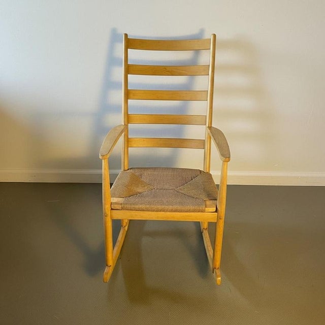 Lovely Hand Wegner style rocking chair made of solid beech wood and chorded seat. In good vintage condition. Some wear and...