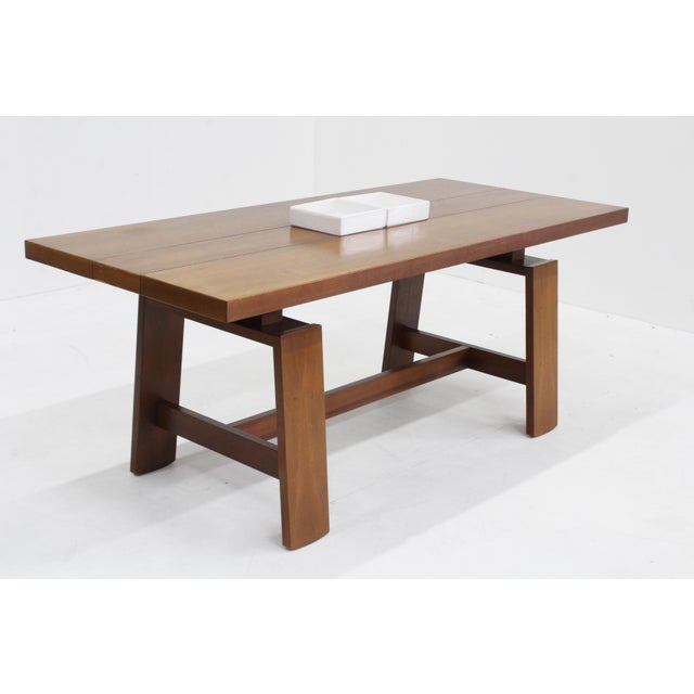 Vintage dining Table by Silvio Coppola for Bernini designed in the 1960s. A walnut dining table designed by the iconic...