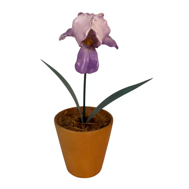 Vintage purple porcelain iris made from finished with tole leaves. Potted in a terracotta pot. Spanish moss placed on top...