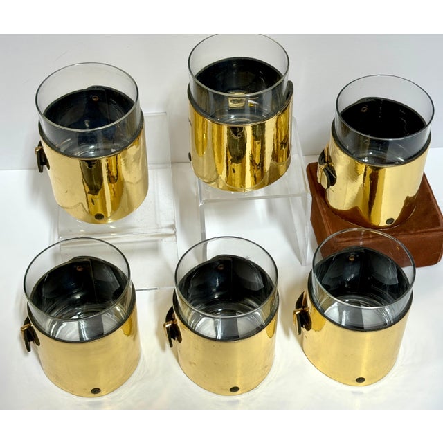 Set of Six Italian Gold-Plated/Finished Leather Horsebit Old-Fashioned Glasses, Style of Gucci, 1970s A striking and...