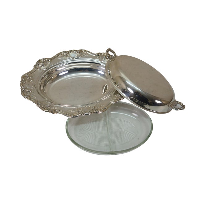 Three vintage lidded, footed silver plate tureens or casserole dishes. One Reed & Barton Burgundy scalloped floral...