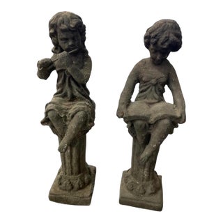 Pair of Vintage European Style Cast Iron Seated Putti Statues on Fluted Pedestals For Sale