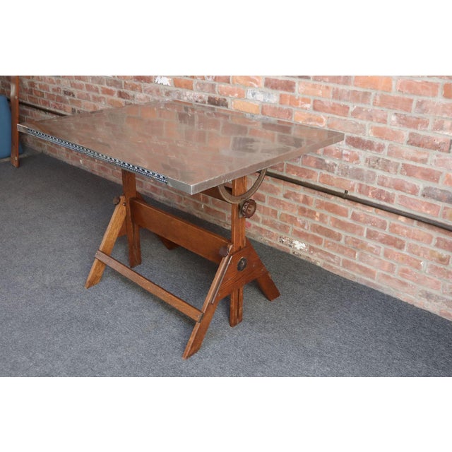 Industrial drafting table/desk in oak with steel surface, fully adjustable via cast iron hinges, knobs, and brackets...