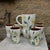A mid-20th-century french handcrafted ceramic coffee or orangeade set, made in the style of vallauris pottery. Against a...