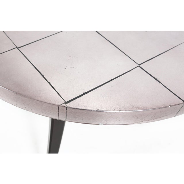 Charming small French coffee table with nice tripod curved legs from the 1980s. Made of wood with formica top in aluminum...