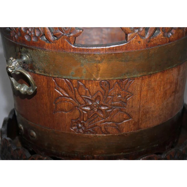 Mid 19th Century oak carved bucket on stand, possibly Scandinavian, the bucket has two brass handles and the stand has one...