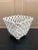 An elegant trompe l'oeil porcelain cachepot crafted in the form of a handwoven rope basket. Executed in glossy white...