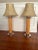 Mid century pencil reed table lamps. Chrome base and wood accents. Vinyl shades similar to a faux goatskin design. The...