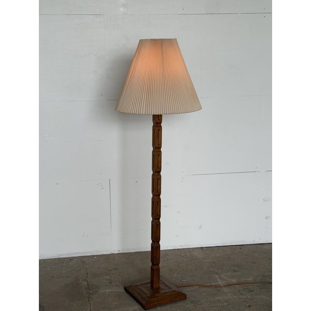 A Danish oak brutalist floor lamp, 1960s–1970s. The stem is a square-section oak column carved with repeating recessed...