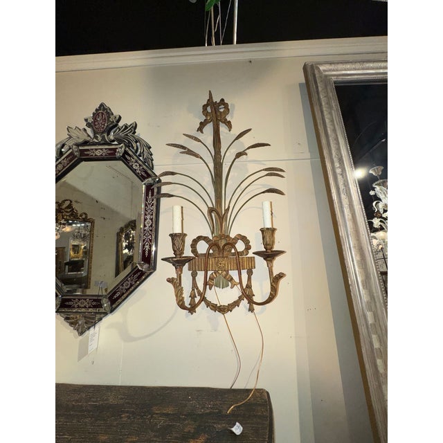 The product is a pair of 19th century Italian giltwood wheat sconces. adding a soft and cozy ambiance to any room. Made...