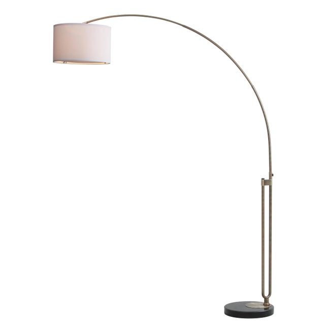 Eloquent in it's expression of pure geometry, this dramatic arc floor lamp moves with ease from transitional to...