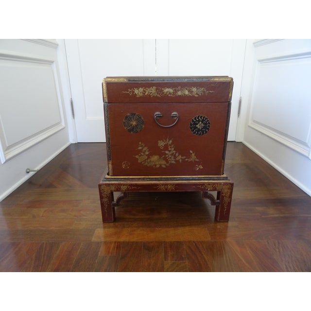 Red lacquer and hand painted leather trunk with leather lining on inside. Great for at the foot of a bed or a wonderful...