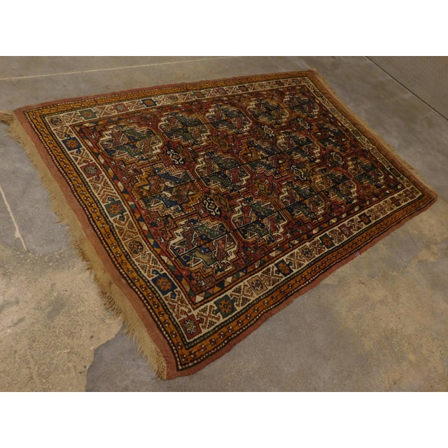 Antique Persian rug displaying Geometric motifs. Wool pile on wool foundation. 5'5"x 7'7"