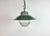 Industrial hanging lamp manufactured in Poland during the 1960s. It features a green enamel shade with a white enamel...