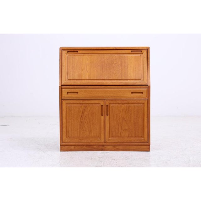Vintage secretary desk by Dyrlund, crafted from solid teak and teak veneer, with a well-designed interior layout. The...