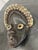 Design Plus Gallery presents a West African Dan Tribe Cowrie Shell Wood Mask. Carved from wood, the mask has an elongated...