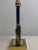 The lamp is made in the contrasting colors golden brass and black, the column has the shape of a skyscraper. An item with...