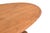 This Vintage Indian Blonde Teak Coffee Table is handcrafted from solid teakwood, featuring an oval top supported by...