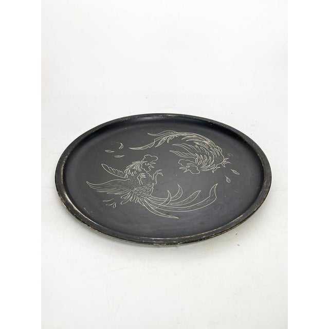 Round black-painted metal tray with white decoration, France, 1960s. Elegant decorative tray in black lacquered metal...