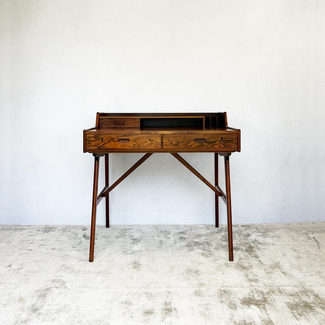 Danish Model 65 desk attributed to Arne Wahl Iversen. Rosewood throughout with dramatic grain figuring across desktop and...