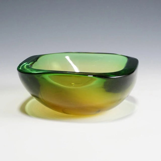 A heavy sommerso glass bowl attributed to vetreria gino cenedese, circa 1960. yellow, green and clear glass. width: 5.71"...