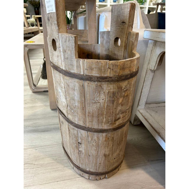 This tall vintage bucket was once a utilitarian staple in rural Asian households, used for carrying water or grain....