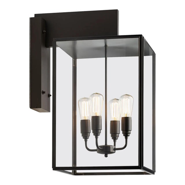 Eclectic wall light in dark bronze with outside fitted clear or frosted glass, closed top and bottom. Wall bracket in...