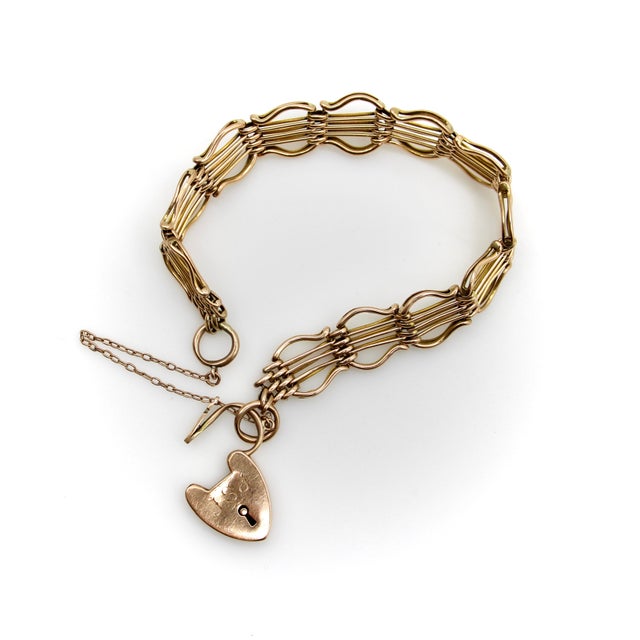 This 9k gold English Victorian gate bracelet is a variation of a classic design that uses the parallel lines of the...