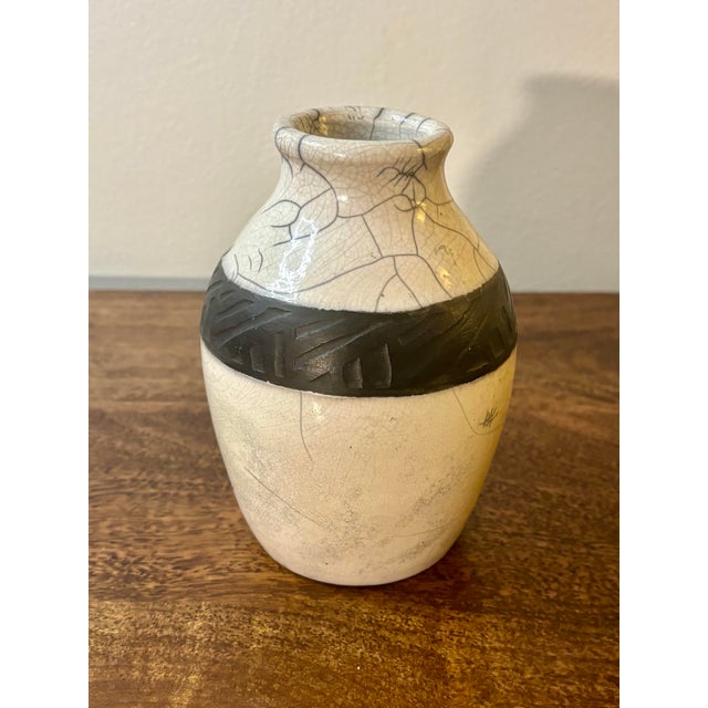A striking American mid-century studio pottery vase, hand thrown and finished in a white crackle Raku glaze with a carved...