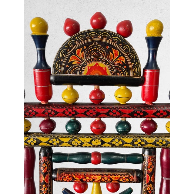 A striking vintage hand-painted folk art accent chair with exceptional decorative presence and craftsmanship. This piece...