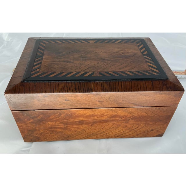 Beautiful antique walnut box inlaid with rosewood and ebony. Hinged lid.