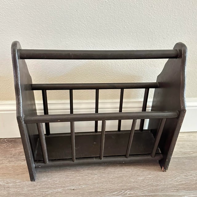 Very dark brown vintage solid wood magazine rack.
