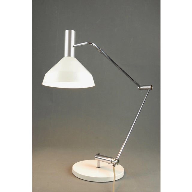 This Type 60 T lamp was designed by Rico and Rosemarie Baltenweiller in 1957. The shade is made of white lacquered...