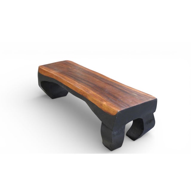 This contemporary bench is hand carved from one single piece of wood and finished in two tones, ebony and brown. With its...