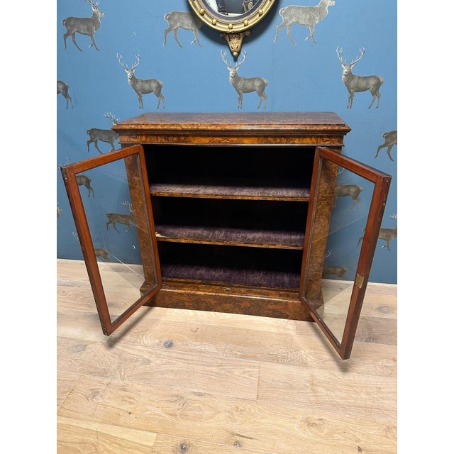 Beautiful small 2-door bookcase/display case in walnut. Completely in original condition. The shelves are also finished in...
