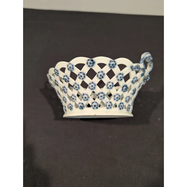 A rare and early Meissen porcelain reticulated basket, hand-painted in cobalt blue with applied florets at each lattice...