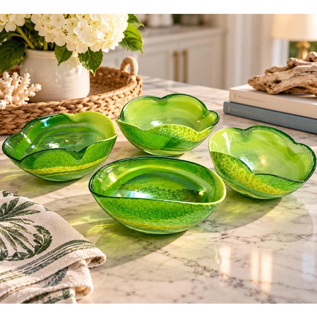 A striking collection of four vintage Italian Murano art glass bowls featuring vibrant emerald, lime, and yellow-green...