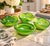 A striking collection of four vintage Italian Murano art glass bowls featuring vibrant emerald, lime, and yellow-green...