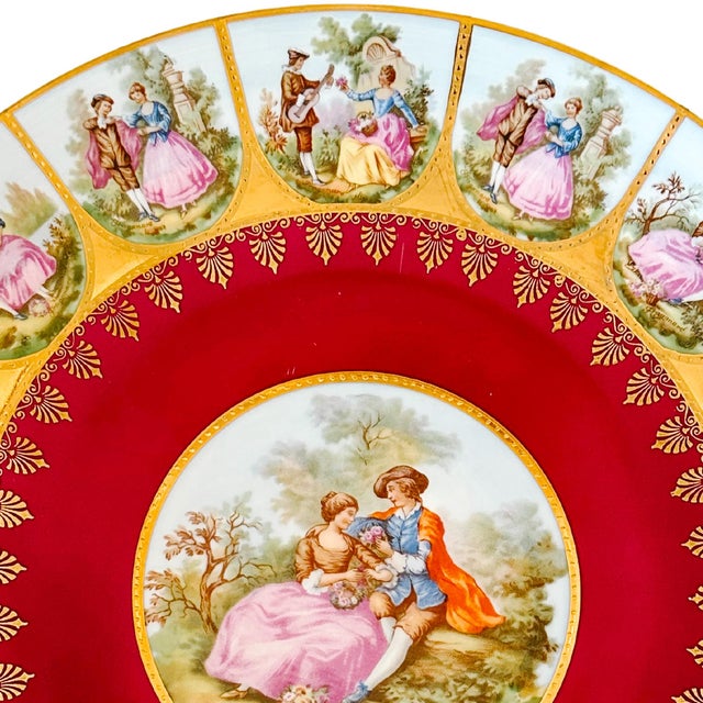 A beautiful decorative plate featuring a large center medallion showing a Victorian scene of Fragonard's courting lovers...