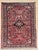 Hand-knotted village rug from the Hamadan region of western Iran, featuring a central floral medallion set within a...