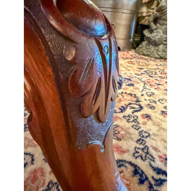 Wood oval pedestal table with ornate feet and rolling wheels. Beautifully carved legs and turned pedestal. Possibly...