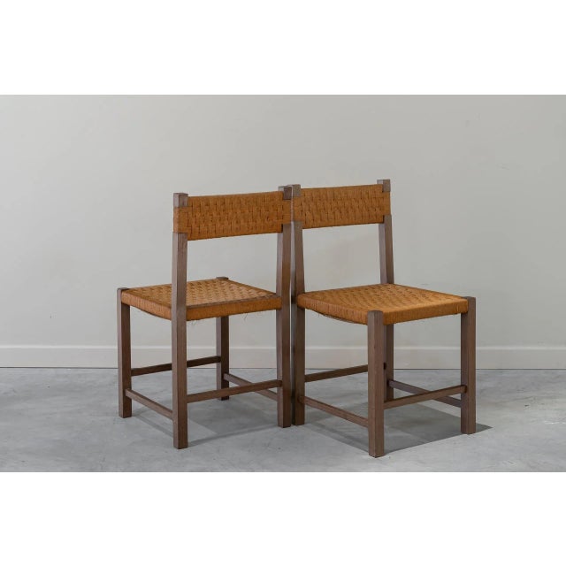 Pair of chairs with wooden frame and rope braided seat and back.