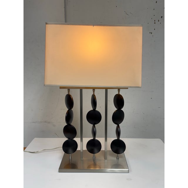 Design Plus Gallery presents a Table Lamp from Robert Abbey. The lamp is showcases a sculptural, architectural presence...