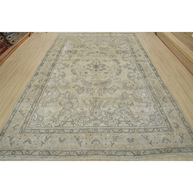 An authentic vintage traditional Tabriz rug hand-knotted with an all-wool pile on a cotton foundation. This oriental rug...