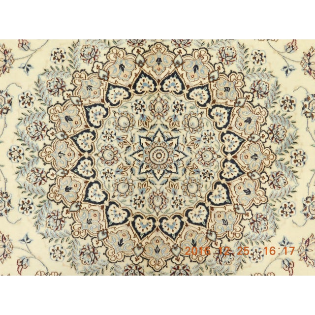 Central medallion on floral decorated, ivory field. Wool and silk high lights on cotton foundation. This is a signature...