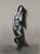 This charcoal drawing presents a figure in a moment of introspection, poised delicately with one hand resting on her face....