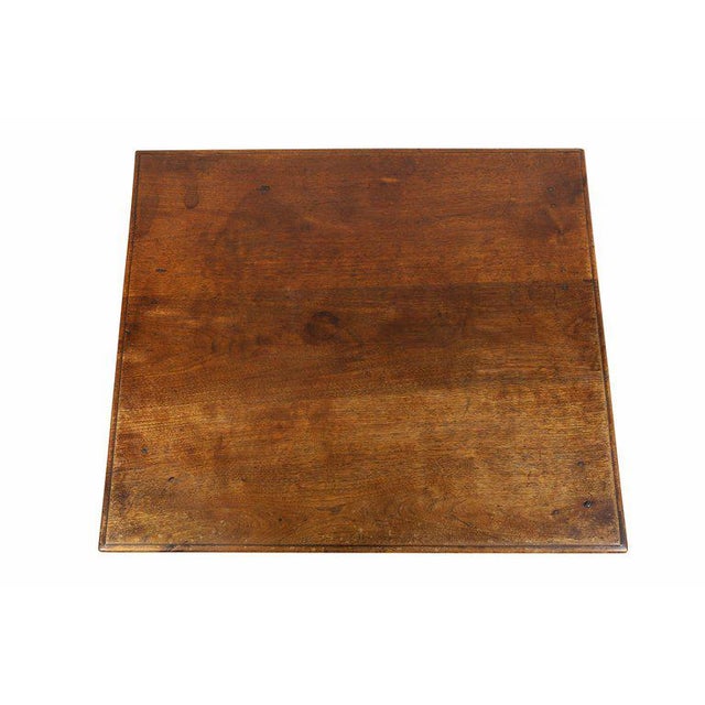 Rectangular top over a single drawer with inlaid escutcheon and original bail handle raised on square tapered legs.